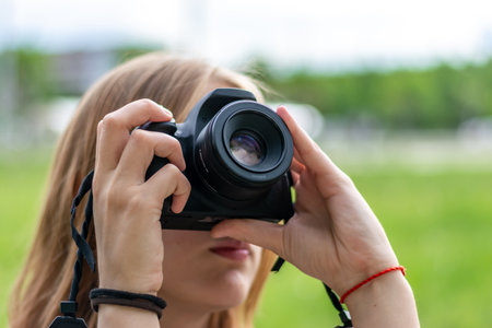 girl takes pictures in nature, close-upの写真素材