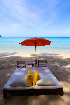 lounge on a beach with orange umbrellaの写真素材