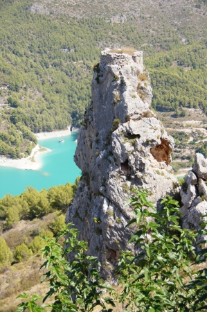 tower of castle on the top of a rock with lake the fund in Guadalest, Spainの写真素材