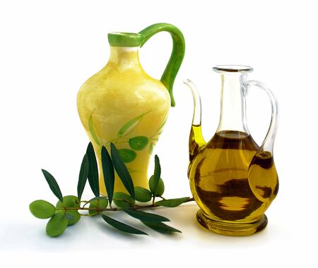 Carafe and small jug containing olive oil. White fand.の写真素材
