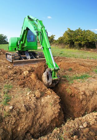 Excavation of a trench by a digger.の写真素材