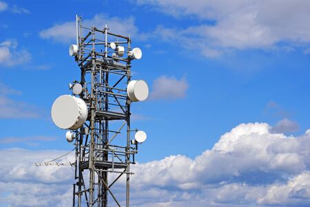 Radar and antennae on a background of blue sky.