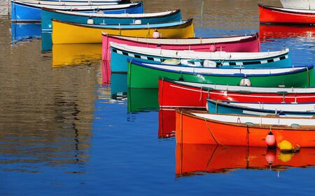 Alignment of small boats in bright colors.の写真素材