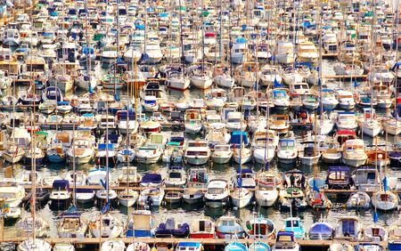 Numerous boats moored in pontoon of a marina.の写真素材