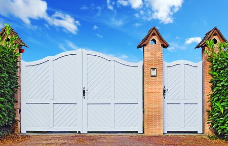 Entrance gate and door supported by beautiful brick pillars.