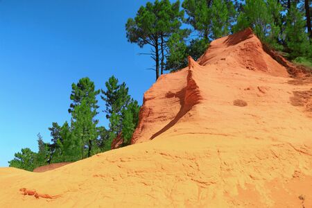 Ocher hill with pines, Roussillon, Provence, France.