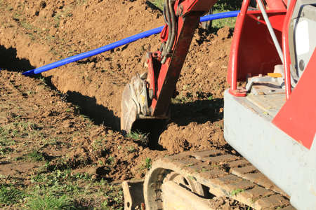 Laying pipes in the connecting trench of a house.