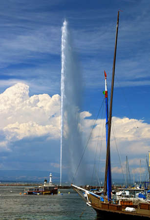 The famous Geneva water jet on a background of sky with summer clouds.の写真素材