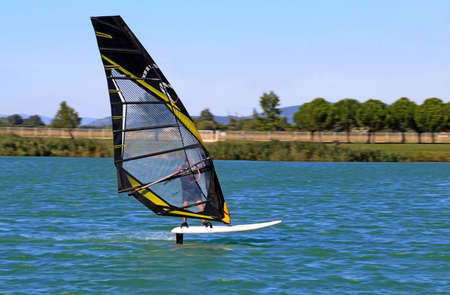 Pierrelatte, DrÃ´me, France, September 02, 2018: On the lake fitted out as a leisure center, windsurfers widely using the wind called Mistral for their greatest pleasure.のeditorial素材