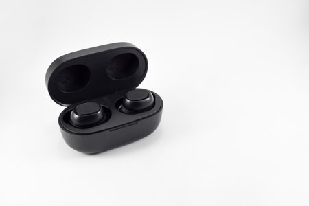 Wireless earphone  voice control with charger isolated on white background. Wireless earphones with its case opened.の写真素材