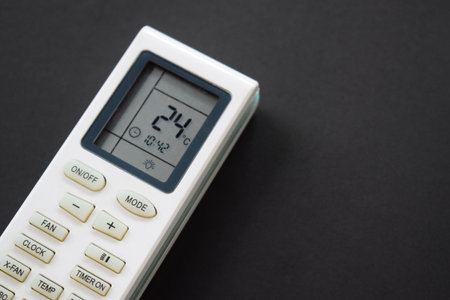 Air conditioner remote on black background. Close up air conditioner 24 degrees celsius