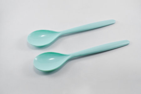 small green plastic spoon isolated on white background.の写真素材