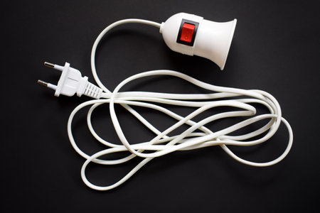 Light bulb socket with long wire isolated on black background. with on off buttonの写真素材