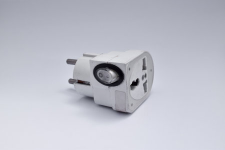 electric plug with on off button on white background close-up