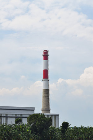 Thermal power plant with smoking chimneys. Industrial landscape. isolated blue sky backgroundの写真素材