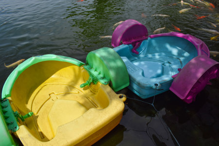 Water boats park on the water, as water rides for children. Vacation spots