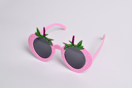 Pink strawberry glasses on white background. For a birthday, disco party, carnival, festivalの写真素材