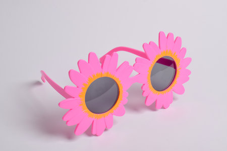 Party or birthday glasses in the shape of pink sunflowers on a white backgroundの写真素材