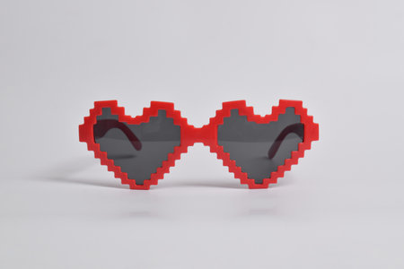 Red love pixel glasses on white background. For a birthday, disco party, carnival, festivalの写真素材