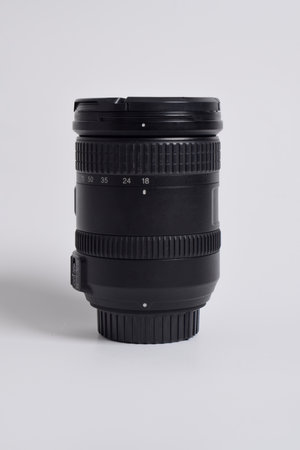 Close up shot of DSLR camera lens 18-200mm isolated on white background