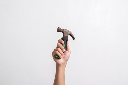 Hand hoding Old rusty hammer isolated on white backgroundの写真素材