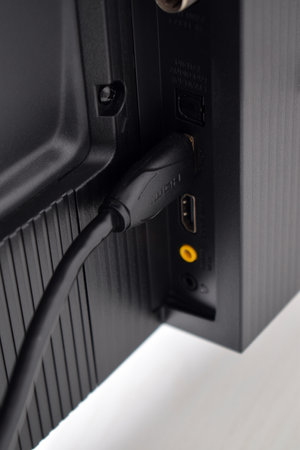 Protected hdmi cable connected to the monitor. The HDMI cable is connected to the TVの写真素材