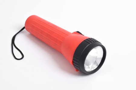Red color flashlight isolated on white background. Battery-powered red flashlightの写真素材
