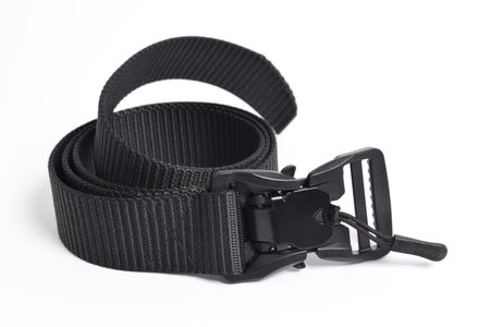 Black mens nylon fastening belt isolated on white background. Men's outdoor military tactical belt.の写真素材