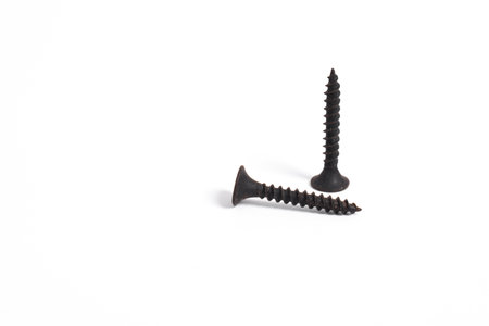Black metal self-tapping screws isolated on white backgroundの写真素材