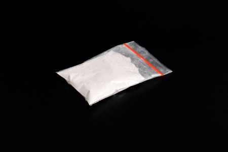 Cocaine in plastic packet isolated on black background. illustration of illegal drug substances,...