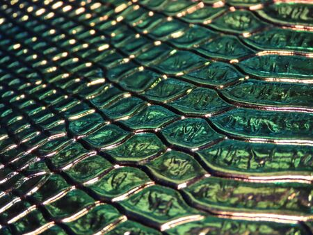 Background texture: light from various angles on a crocodile pattern embossed holographic surface...