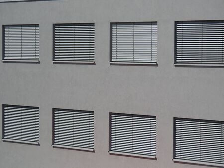 Heat wave in the city: automatic shutters closed on all windows to keep the rooms coolの写真素材