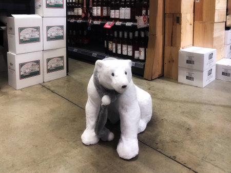 Christmas decoration - big white baby polar bear with shawl - for sale in shop. Walferdange, Luxembourg - December 24, 2020のeditorial素材