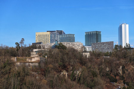 Scenic view to Kirchberg modern high rise buildings and old Grunewald fort walls on an early spring day. Luxembourg, Luxembourg - February 12, 2019.のeditorial素材
