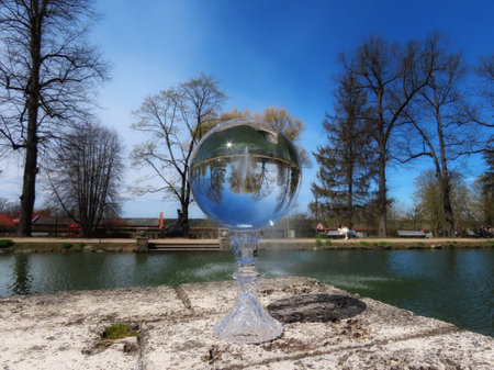 Cesis, May park fountain seen through crystal ball, background blurryの写真素材