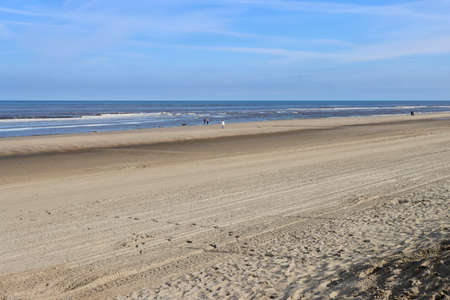 Far away dog walkers on almost empty beach on early morning by North sea in Strand, Noordwijk aan Zee, Netherlands - April 15, 2022のeditorial素材