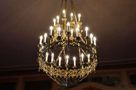 Splendid candelabra with multiple branches, interior detail in luxorious historic hall, electric...