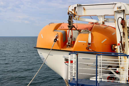 Life boat on ferry. Calm blue sea around. Aboard Stena Line ferry from Travemunde, Germany to Liepaja, Latvia - May 19, 2022のeditorial素材