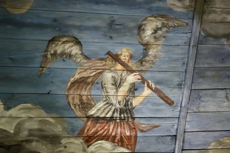 Angel playing music on flute. 18th century decorative painting on ceiling of Usma church in Latvian Ethnographic Open Air museum, Riga, Latvia - May 27, 2022のeditorial素材