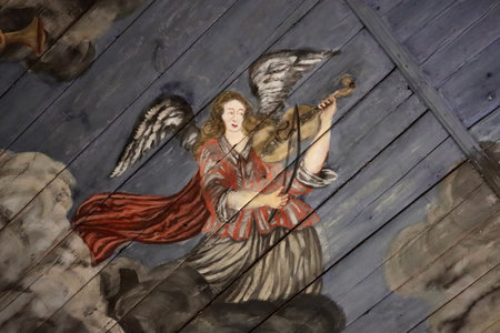 Angel playing music on violin. 18th century decorative painting on ceiling of Usma church in Latvian Ethnographic Open Air museum, Riga, Latvia - May 27, 2022のeditorial素材