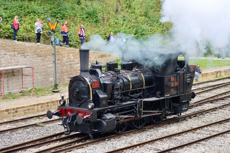 Steam locomotive driving on railway tracks, side view. Fond-de-Gras, Luxembourg - September 25, 2022のeditorial素材