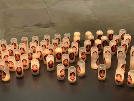 Lit votive candles with St. Willibrord picture in Echternach Basilica, Luxembourg - November 9, 2022のeditorial素材