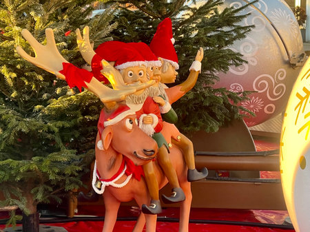 Funny figure of three Christmas elves riding a reindeer. Luxembourg, Luxembourg - December 17, 2022のeditorial素材