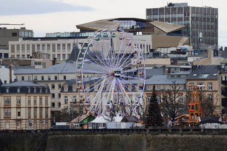 Ferris wheel in Christmas market in Luxembourg, Luxembourg - January 1, 2023. Early morning dim light, selective focusのeditorial素材