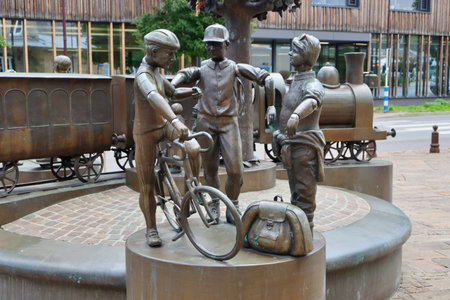 Group of bronze statues of passengers and train next to train station. Diekirch, Luxembourg - September 19, 2022のeditorial素材