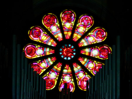Modern stained glass rosette window and organ pipes in Echternach St. Willibrord Basilica church. Luxembourg, Echternach - April 10, 2023のeditorial素材