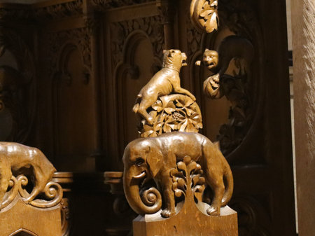 Traditional wood carvings in the interior decorations of Basilica of St. Willibrord: Elephant with tree and another carving of a dog behind it. Echternach, Luxembourg - April 10, 2023のeditorial素材