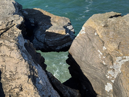 Beach view in Peniche, Portugal. High clifs and crushing waves