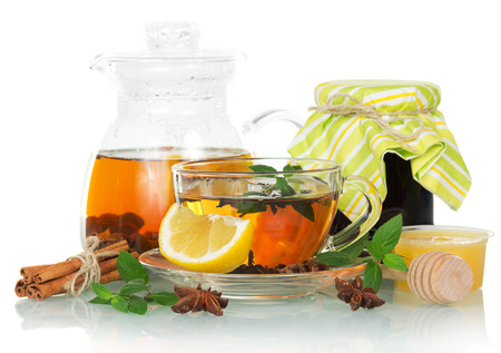 Cup of tea with mint and a lemon on the whiteの写真素材