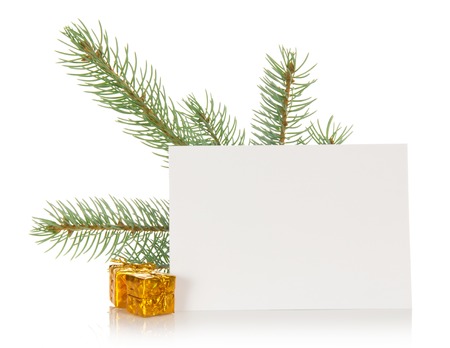 Fir-tree branch, small gift boxes and the empty card isolated on whiteの写真素材